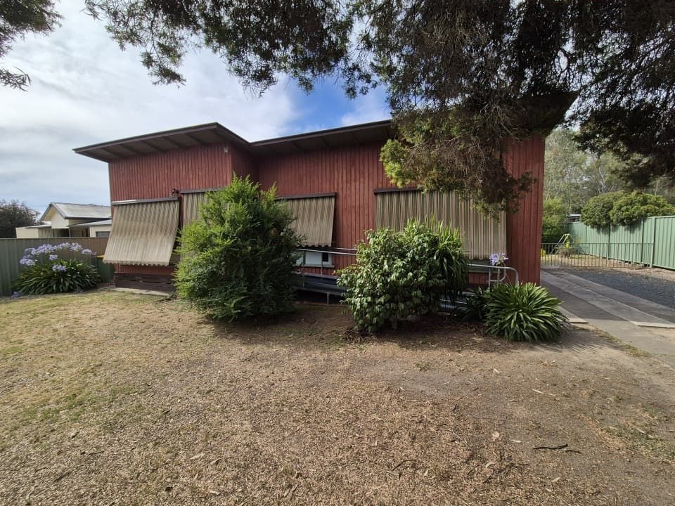 Red-Brown Building With Closed Window Blinds — The Roofer Troopers in Howlong, NSW