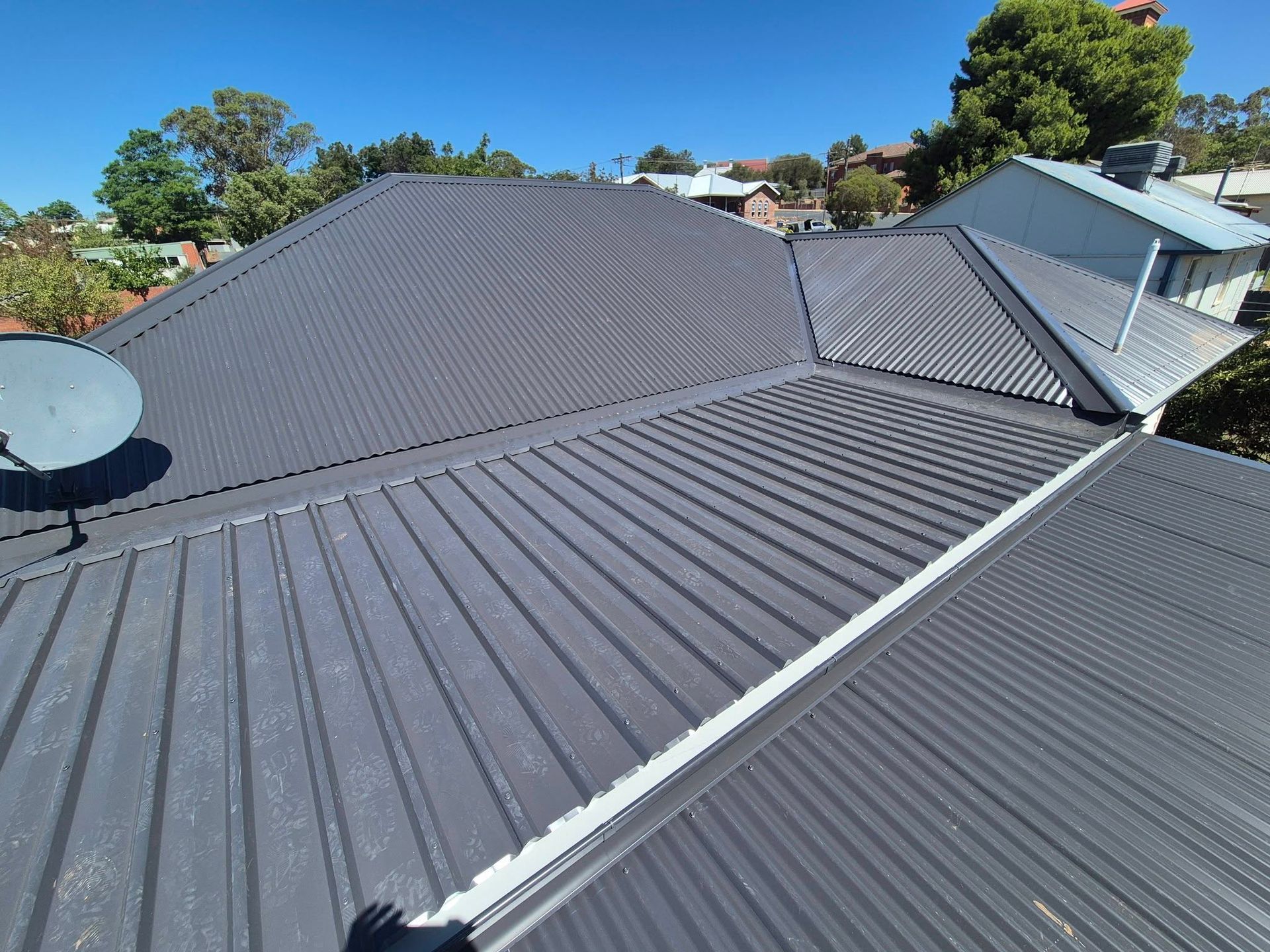 Residential Rooftop With Dark Gray Metal Roofing — The Roofer Troopers in Wodonga, VIC
