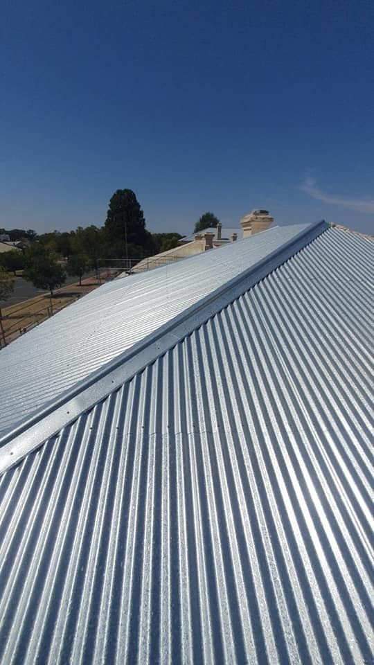 New Corrugated Metal Roof on a House With a Clear Blue Sky in the Background — The Roofer Troopers in Howlong, NSW