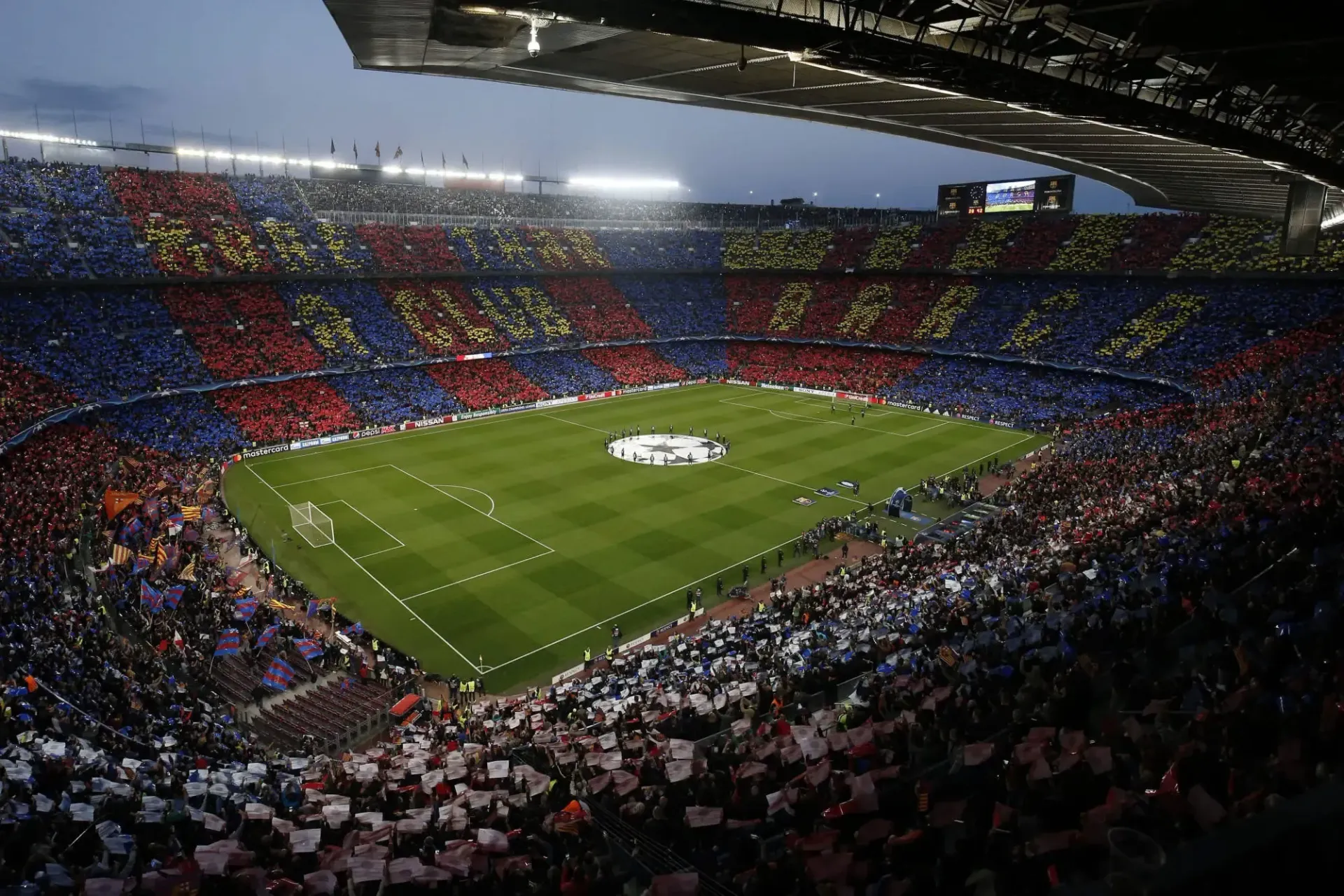 A soccer stadium filled with fans watching a game