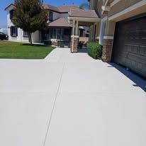 Suburban driveway and walkway leading to a house with a garage and front porch