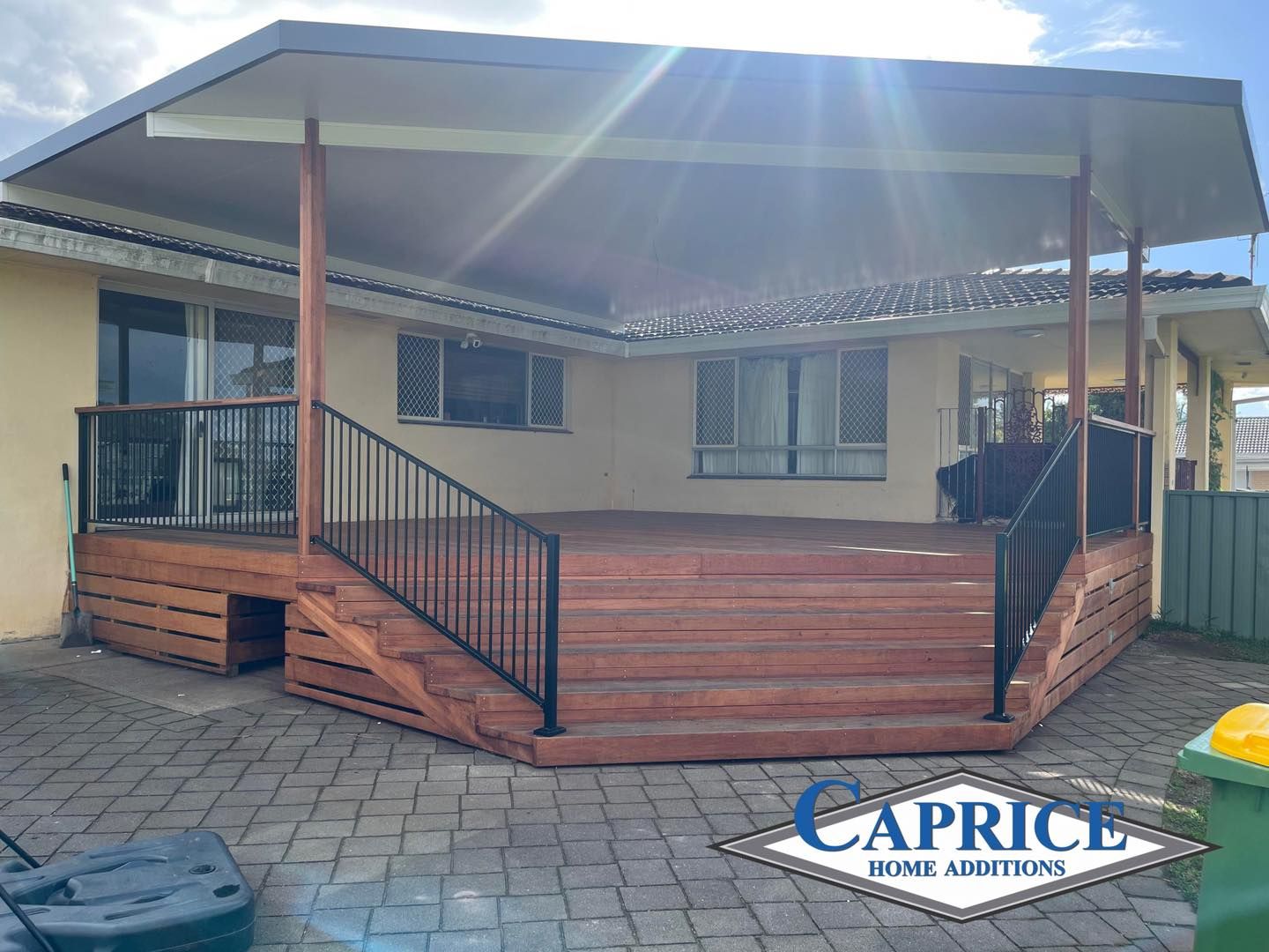 A House With A Spa Bath Under The Porch  Surrounded By Potted Plants — Caprice Home Additions In Taree, NSW