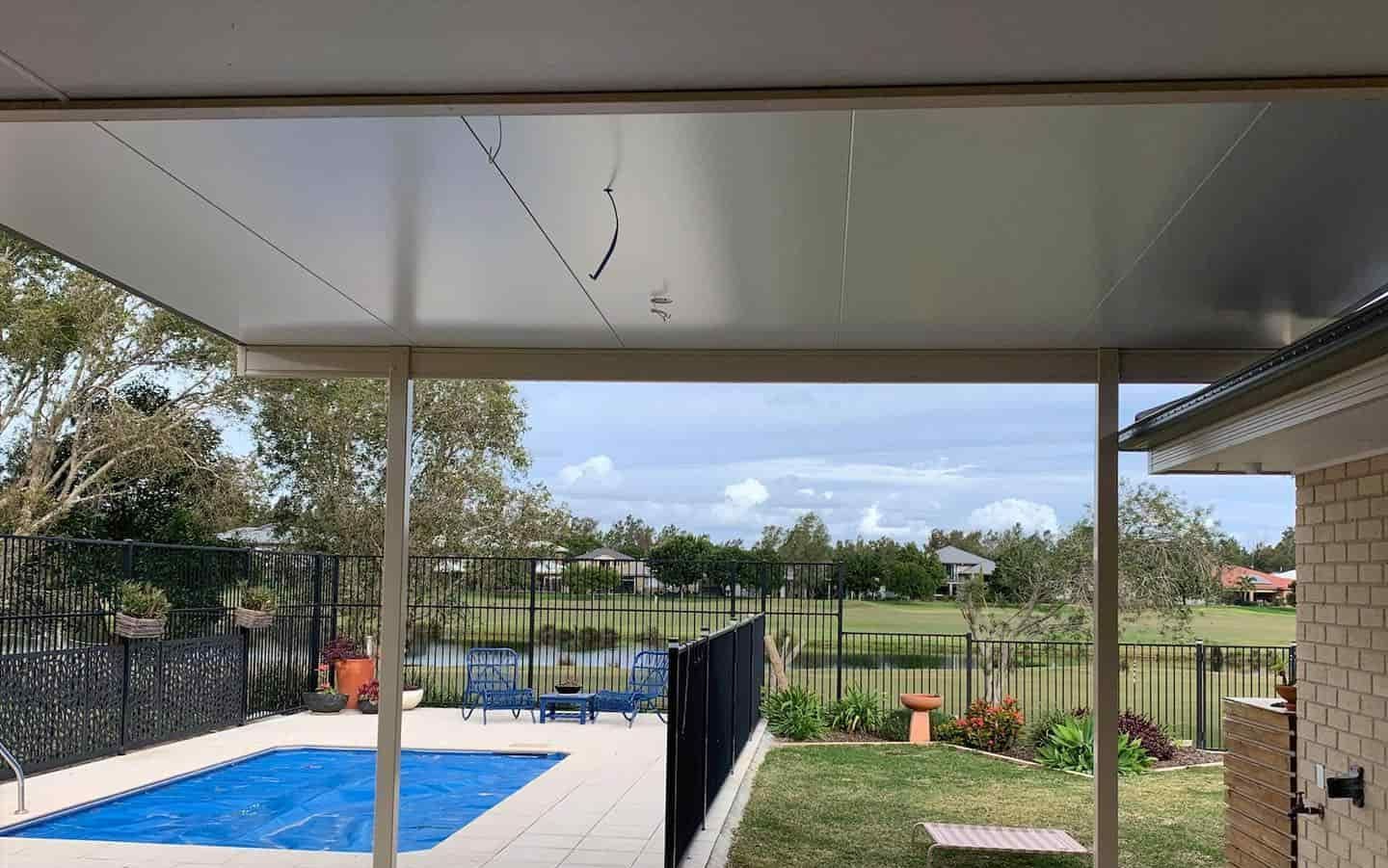 There Is A Swimming Pool In The Backyard Of A House — Caprice Home Additions In Wingham, NSW