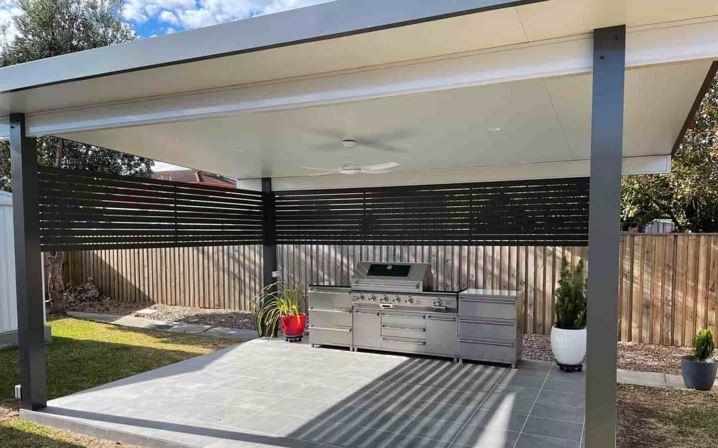 A Patio With A Grill And A Fence In The Backyard — Caprice Home Additions In Gloucester, NSW