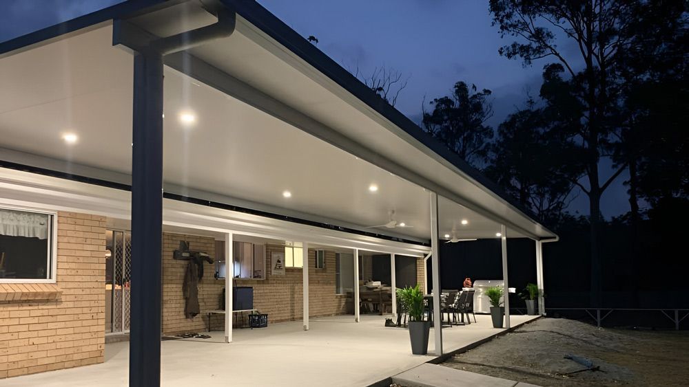 A House With A Large Covered Patio At Night — Caprice Home Additions In Port Macquarie, NSW