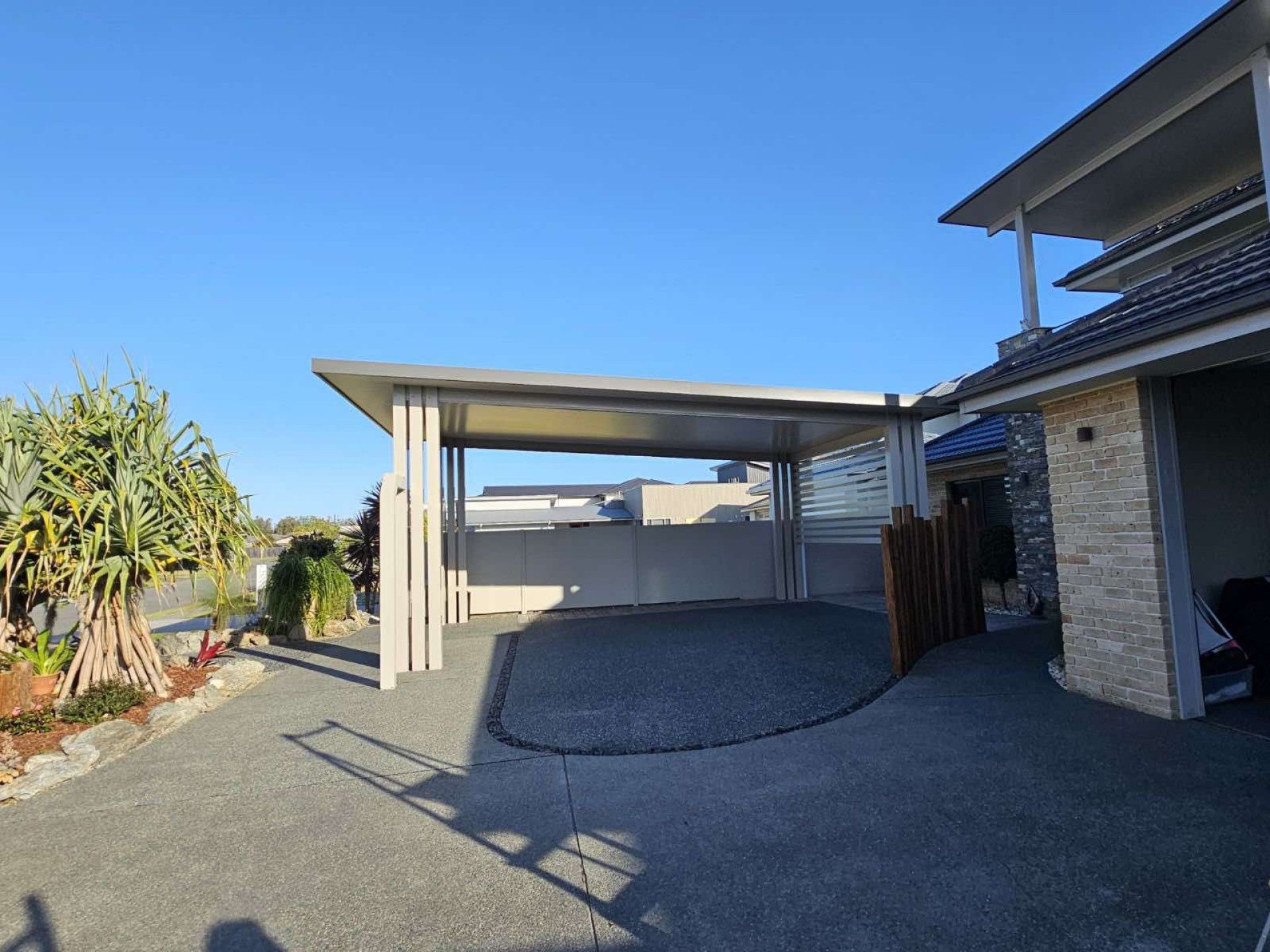 A Carport Is Sitting In Front Of A House — Caprice Home Additions In Taree, NSW