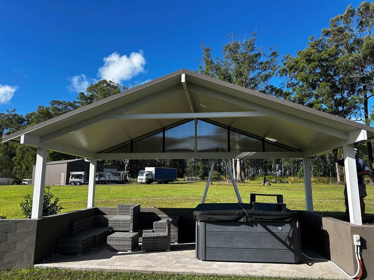 A Gazebo With A Hot Tub Underneath It In A Field — Caprice Home Additions In Old Bar, NSW