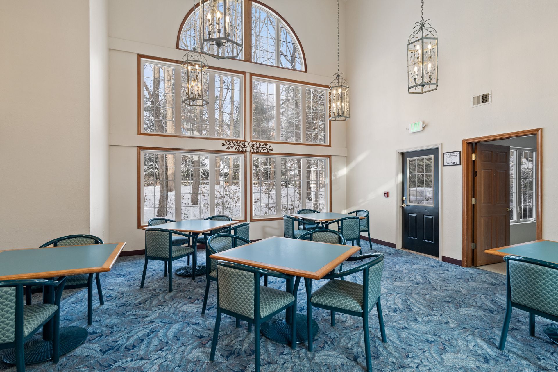 Photo of a part of the great room that has  a set of 6 large windows, allowing for plenty of natural lighting