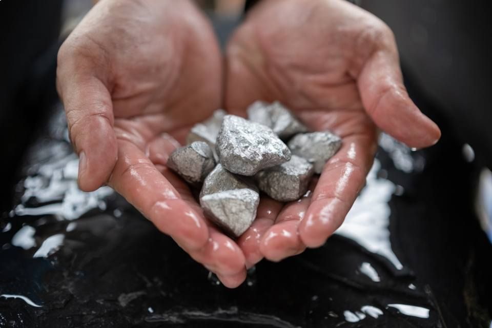 A person is holding a Iron Ore  in their hands.