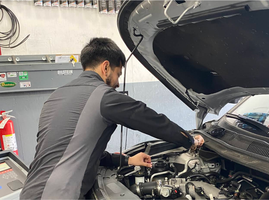 man working on car engine | Mike's Auto Repair