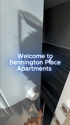 Apartment entrance with door handle and welcome sign reading “Bennington Place Apartments”
