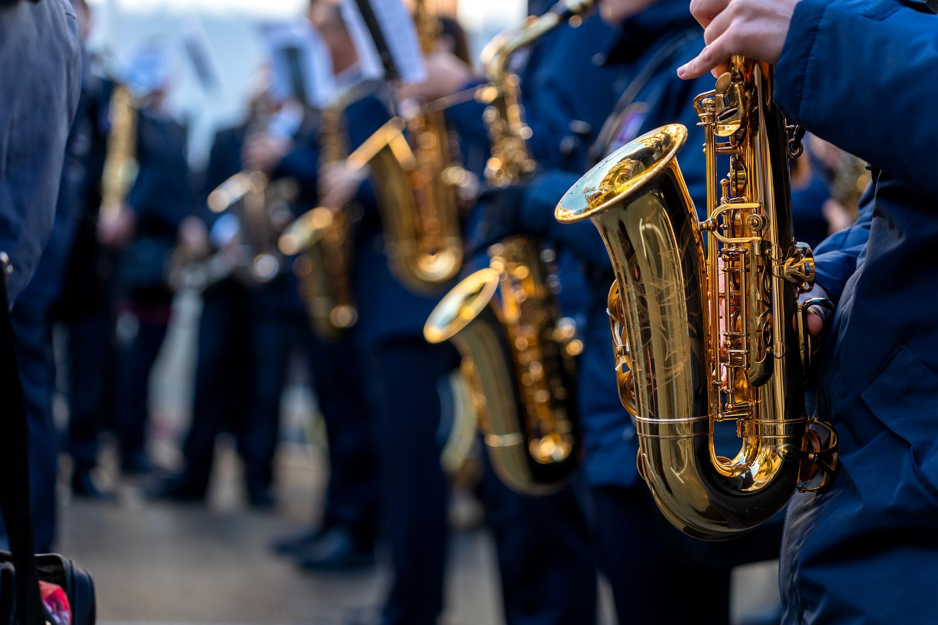 A group of people are playing saxophones in a band.