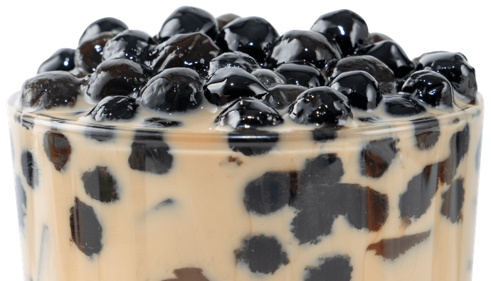 Bubble milk tea with tapioca pearl topping, famous Taiwanese drink on white wooden table background in drinking glass, close up, copy space