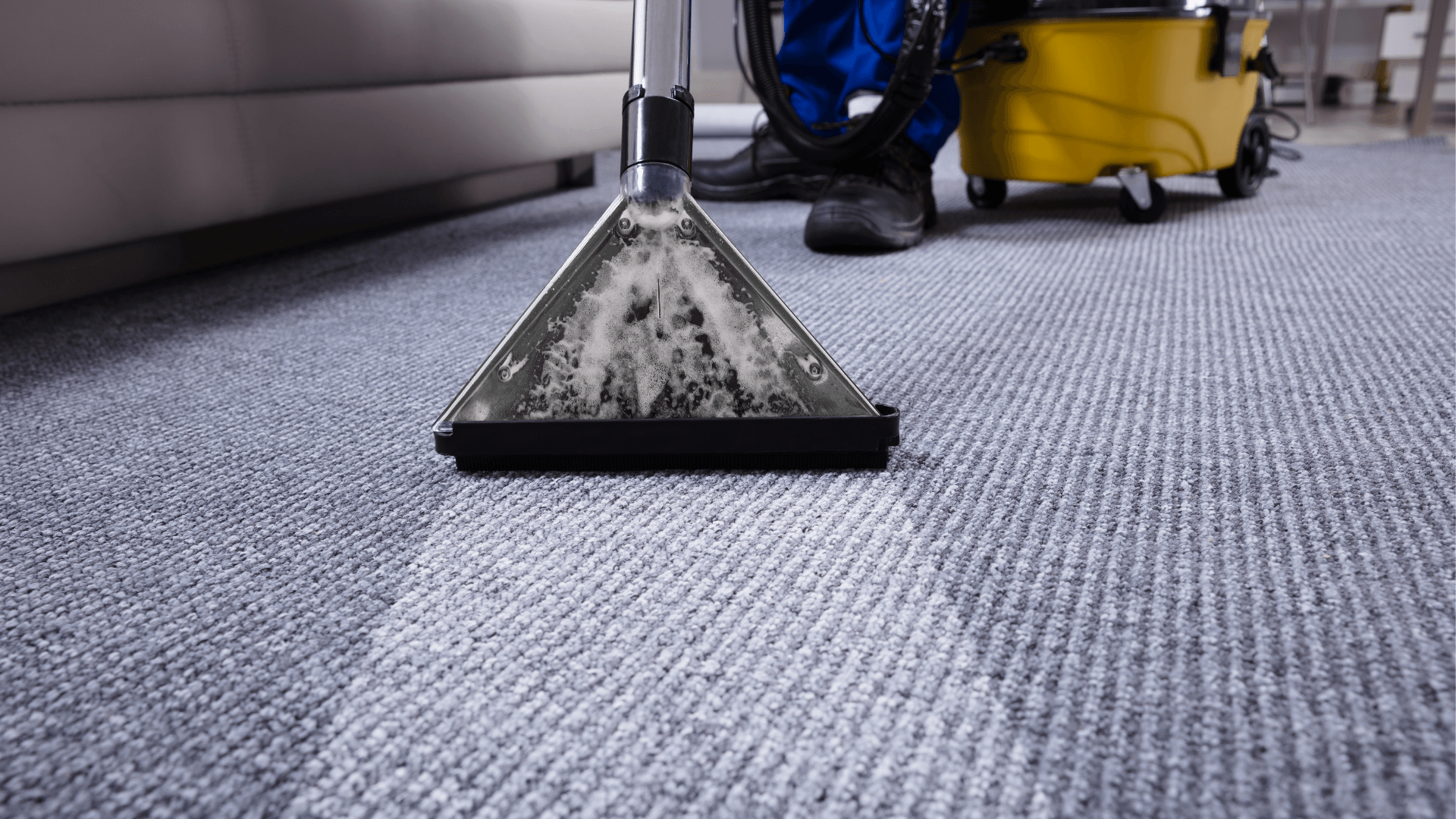 A cleaners sweeping the floor with steam dry cleaning during end of tenancy cleaning service