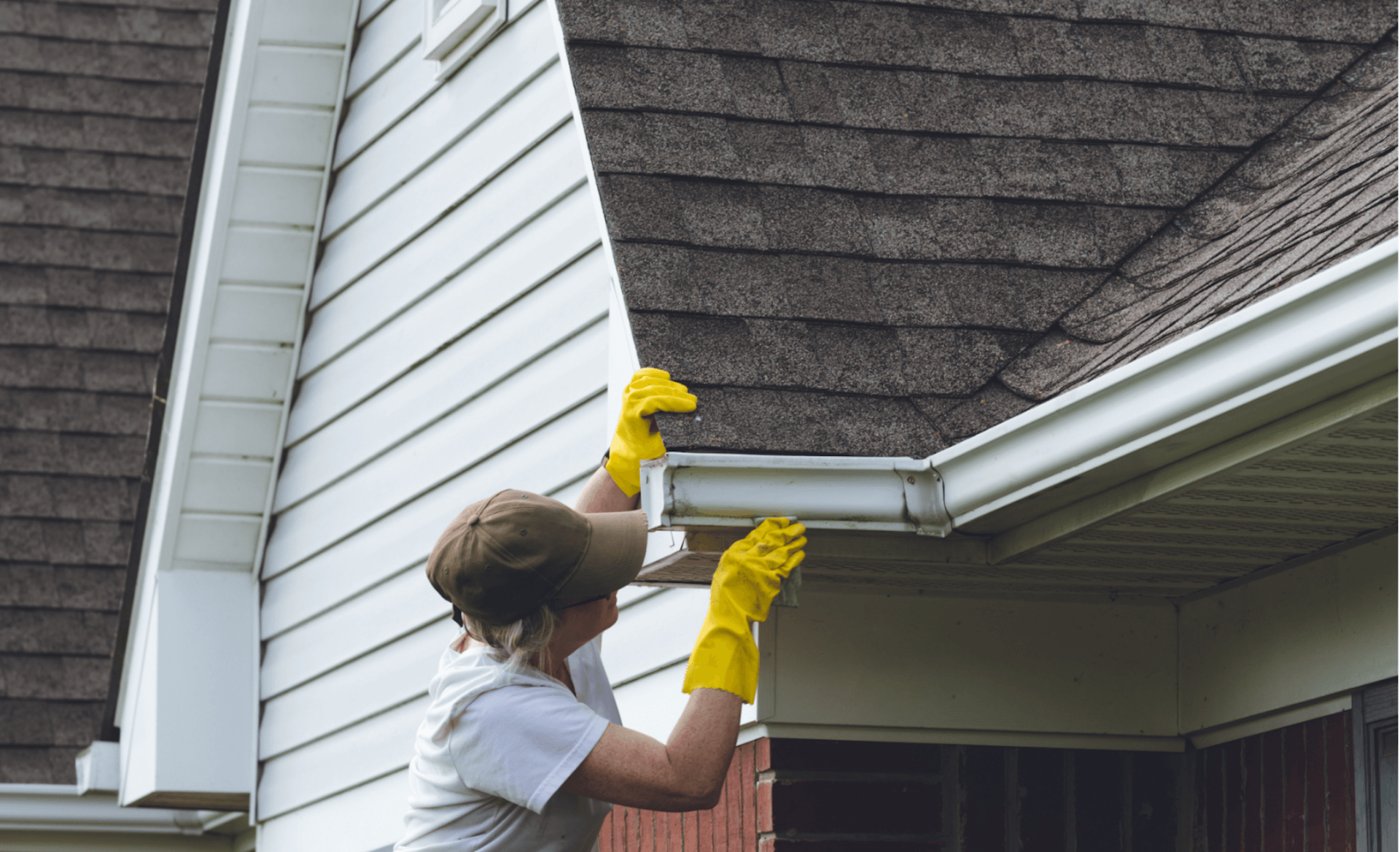 A cleaner cleaning the roof of a house during house cleaning service Maidenhead