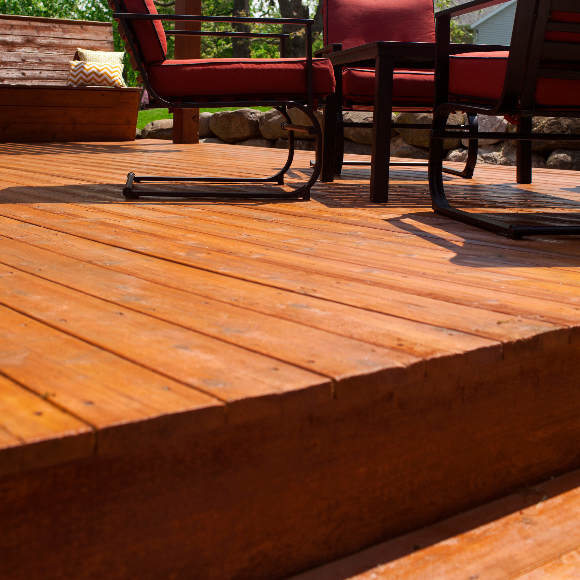A wooden deck with a table and chairs on it