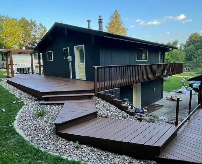 Lakefront home exterior with fresh paint and bright spring sunlight