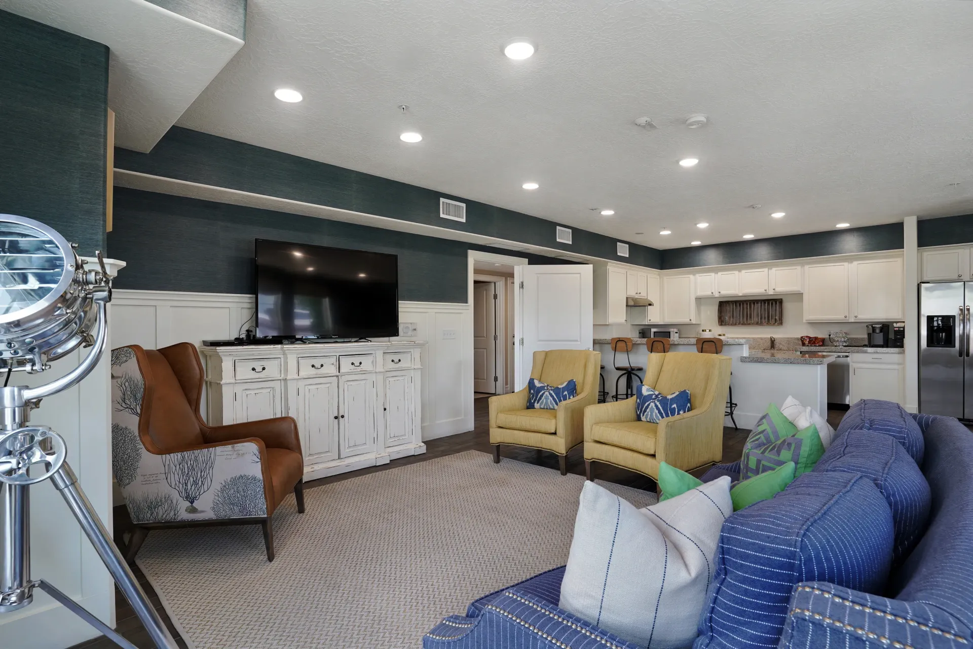 Resident lounge and kitchen area with comfortable seating and modern appliances at Hills at Renaissance, offering apartments in Bountiful, UT.
