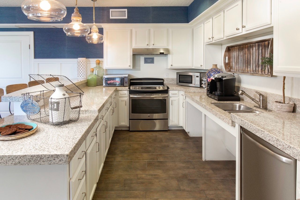 Hills at Renaissance kitchen with white cabinets, granite countertops, and stainless steel appliances.
