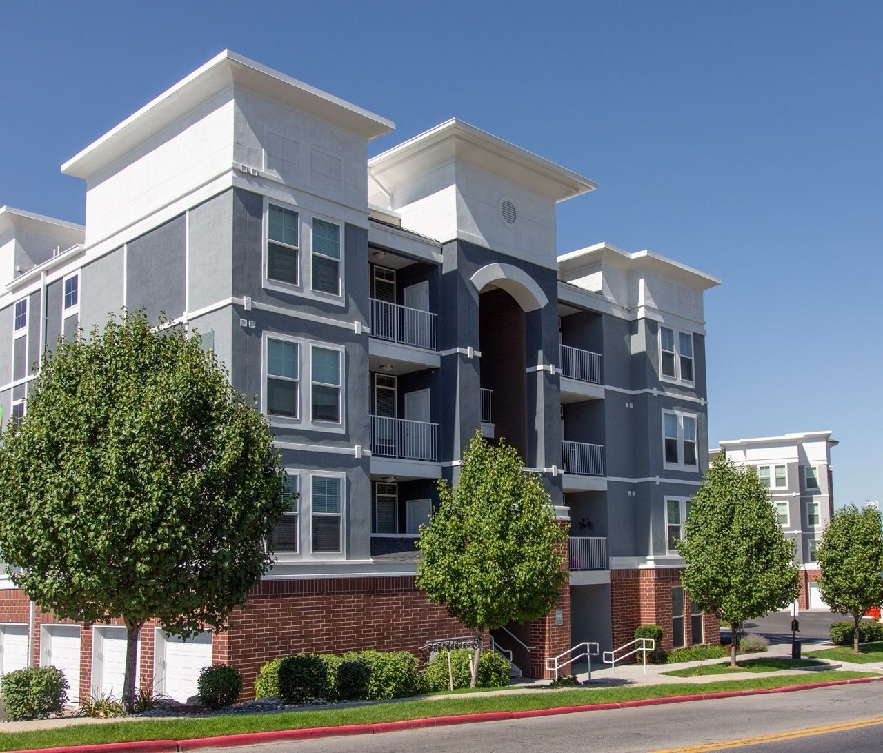 Hills at Renaissance apartment building with balconies and trees.