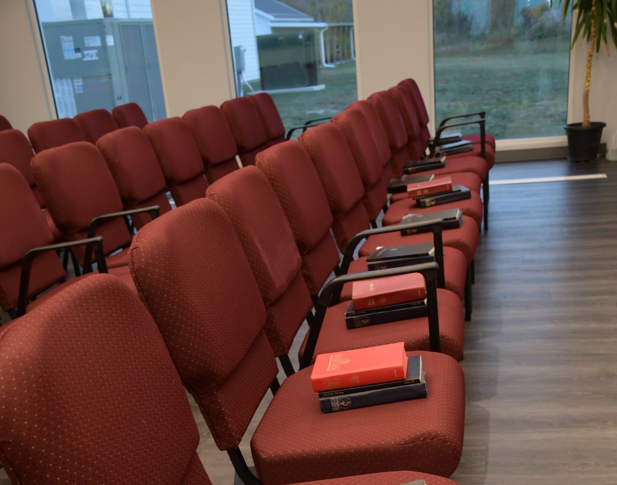 A row of red chairs with books on them