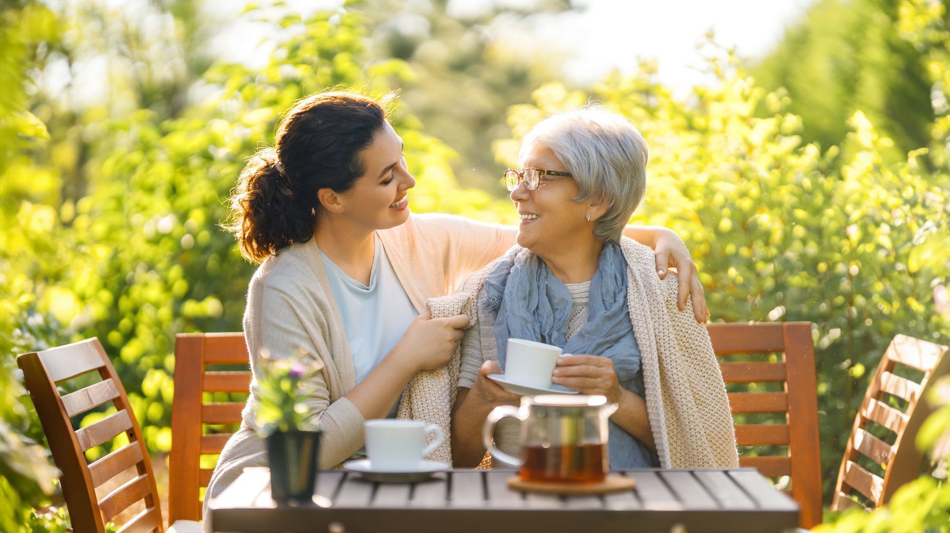 Woman hugs older person