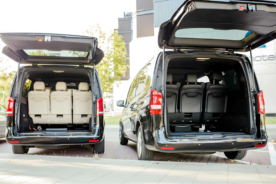 Athenaos Travel & Tours Mercedes minivans with open trunks showing spacious luggage compartments for private transfers.