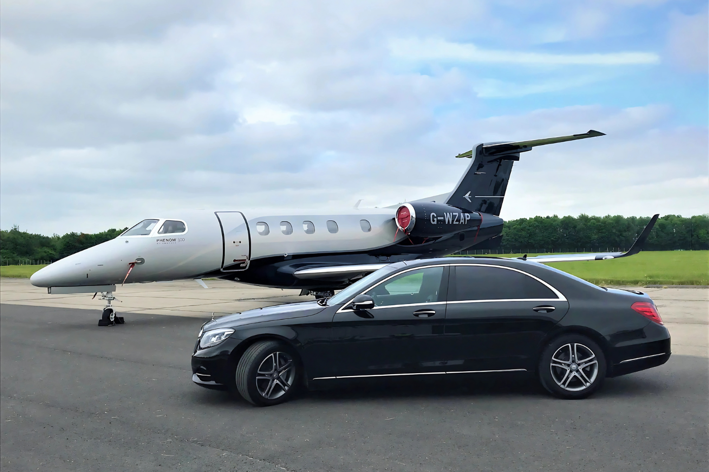 Luxury private car service by Athenaos Travel beside a private jet
