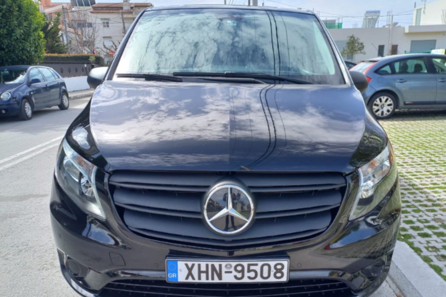 Front view of a black Mercedes van used by Athenaos Travel for private transfers in Greece