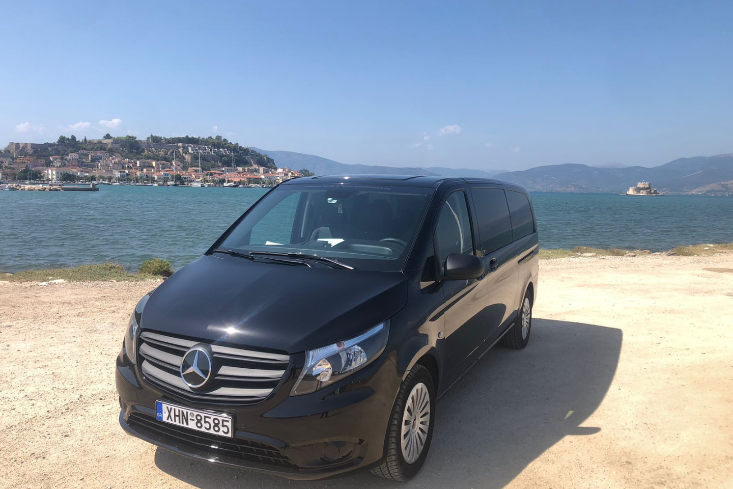 Luxury Mercedes van of Athenaos Travel parked near the sea in Nafplio