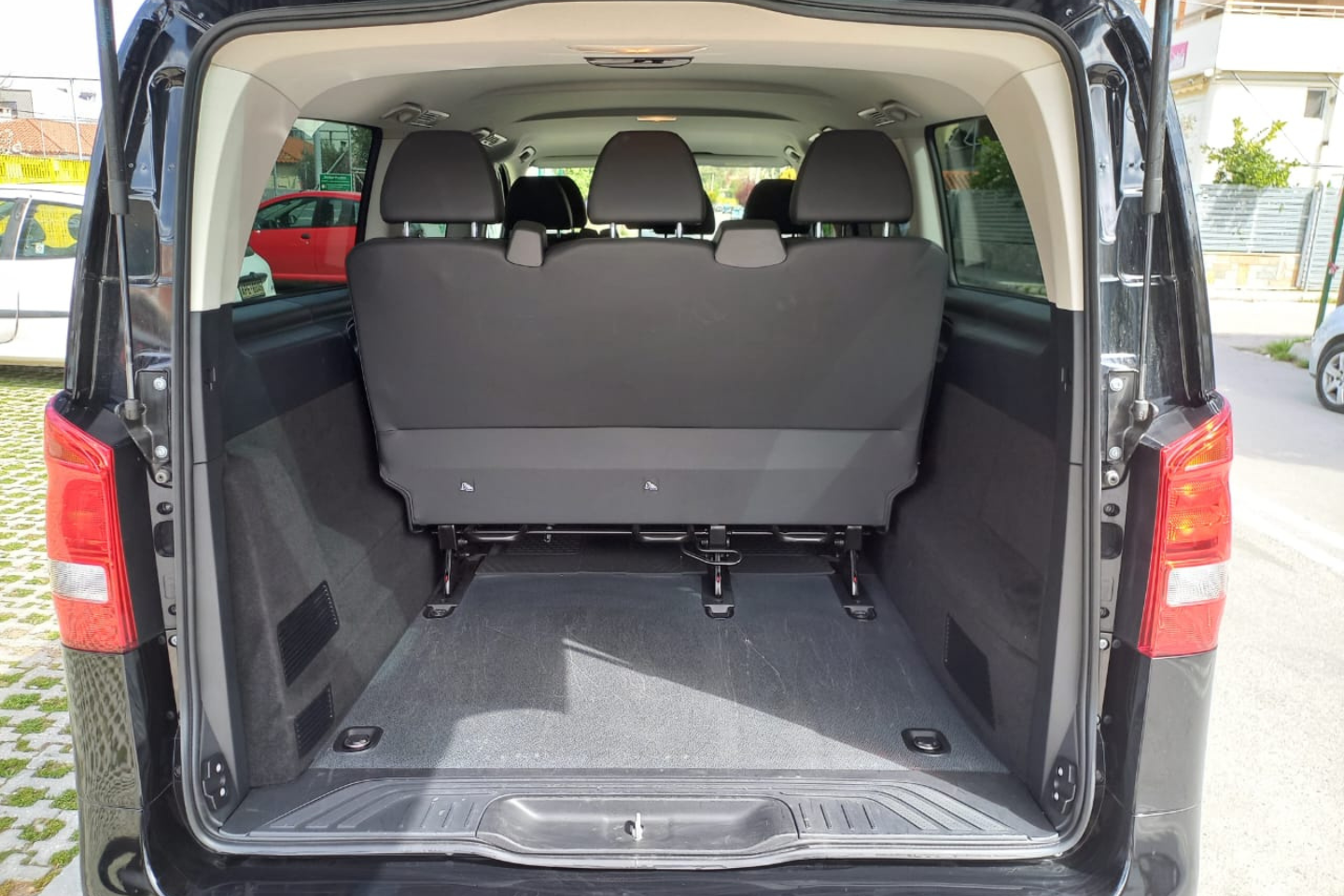 Spacious interior of an Athenaos Mercedes van with the rear door open.