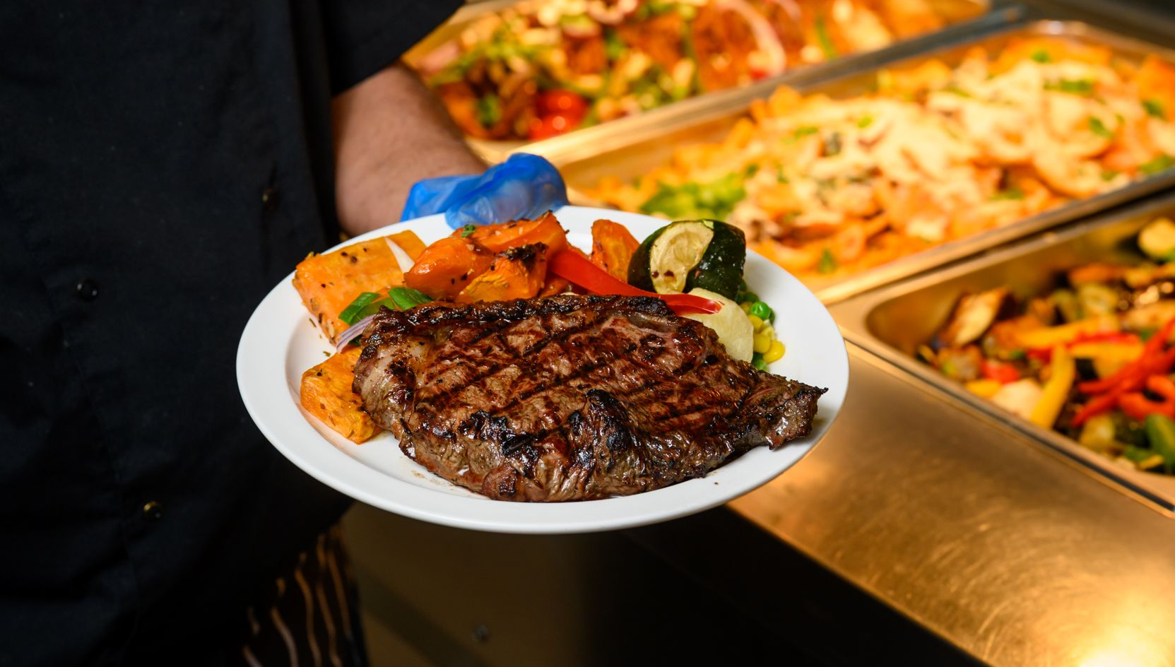 Plate of steak and fresh vegetables served at the Collie Hills Village buffet