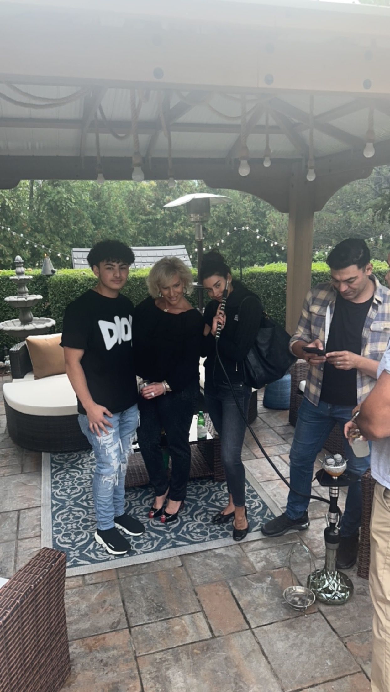 A group of people are standing next to each other on a patio.