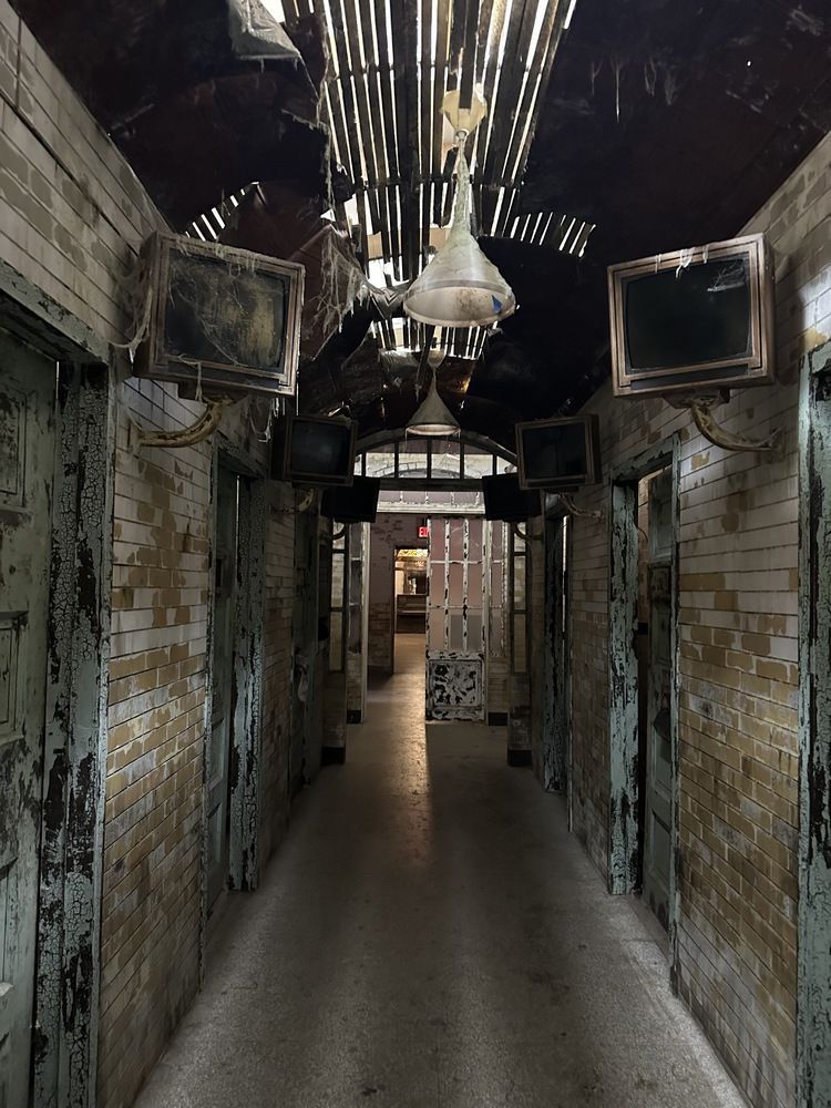 A long hallway with brick walls and a ceiling