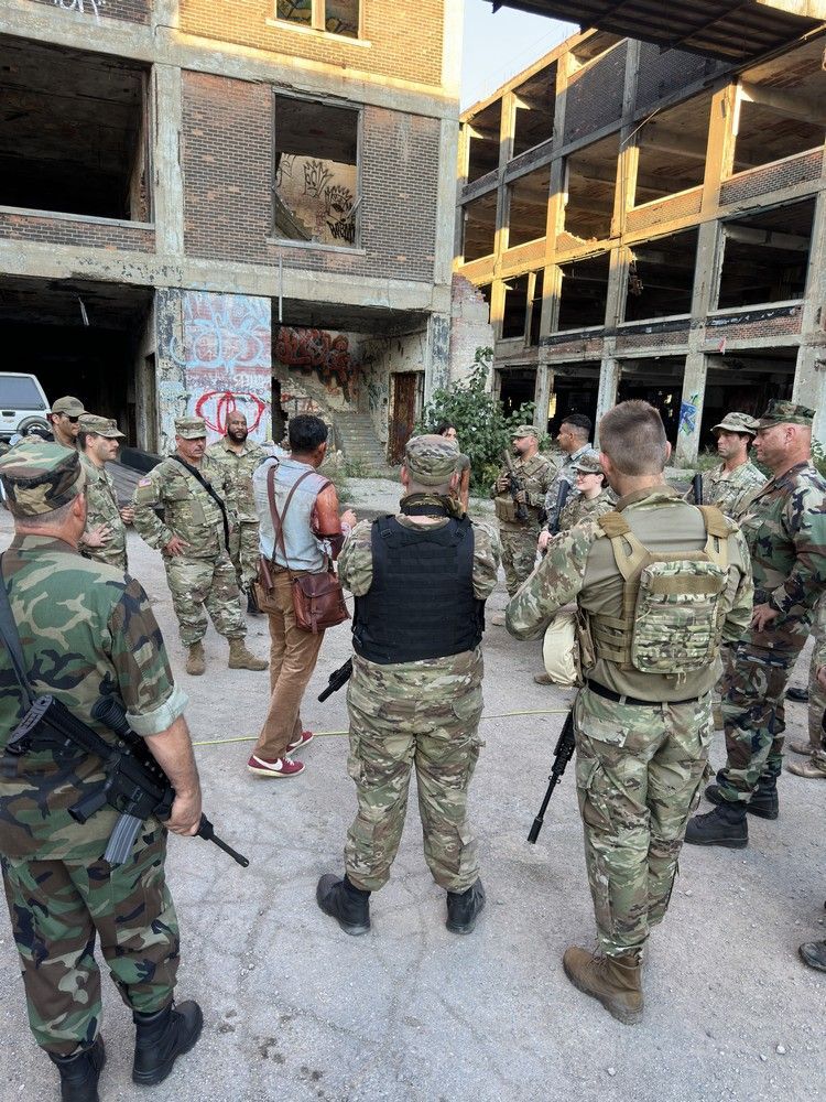 A group of soldiers are standing in front of a building.