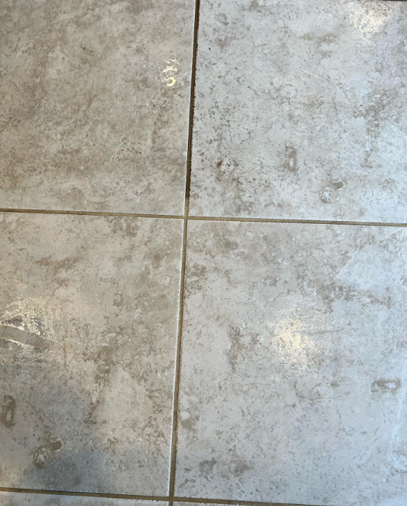 A close up of a tiled floor with white grout.