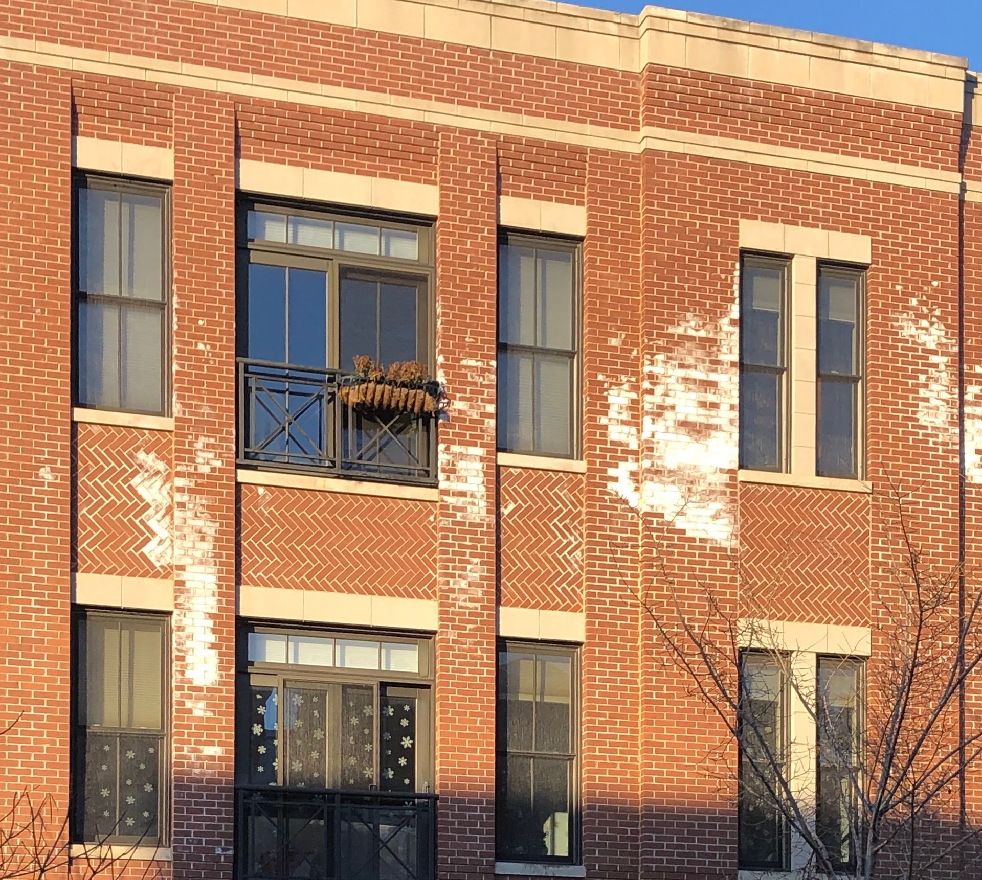Efflorescense on brick columns under Renaissance stone cornice and window headers Lakeview, Chicago