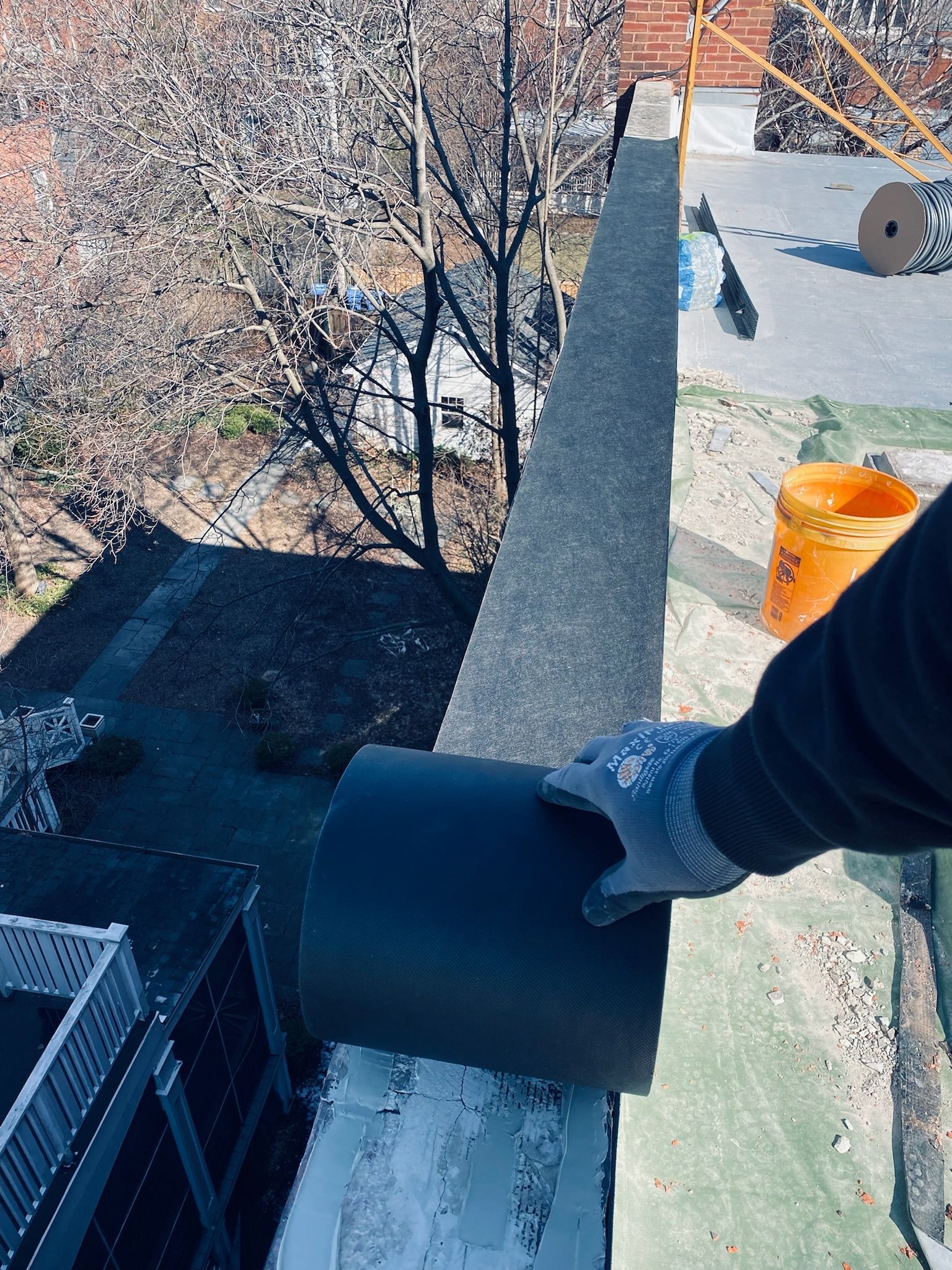 Installing vapor permeable membrane on parapet wall