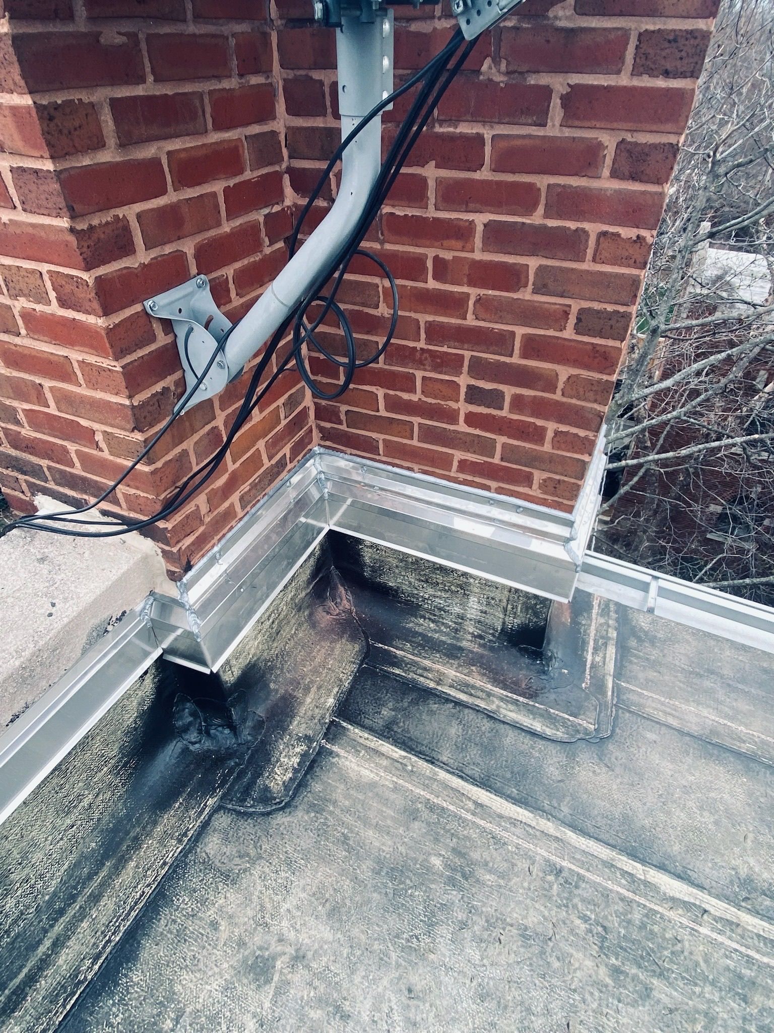 Rooftop corner of brick parapet wall with installed flashing
