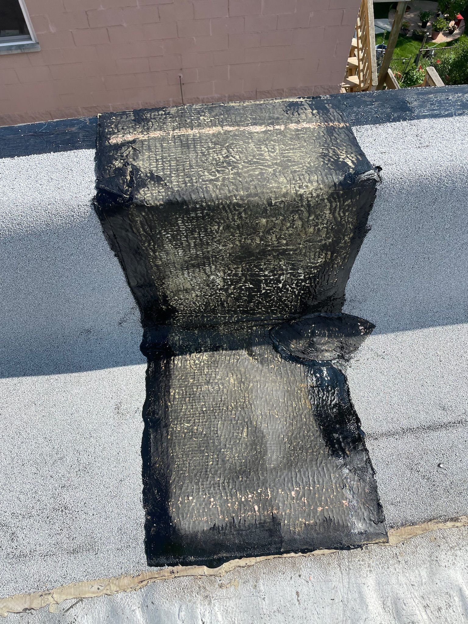 Patch on a flat roof with damaged roof membrane