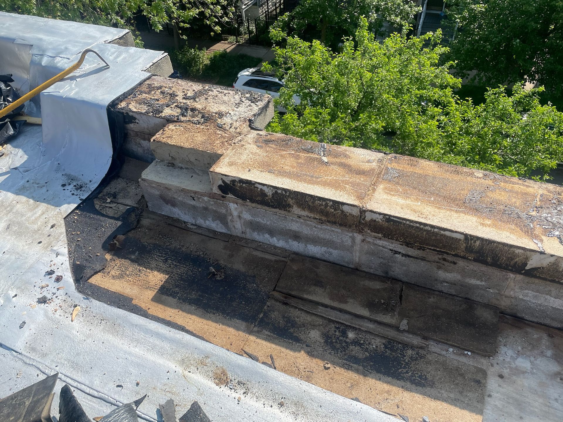 Removed roof membrane from rooftop parapet wall