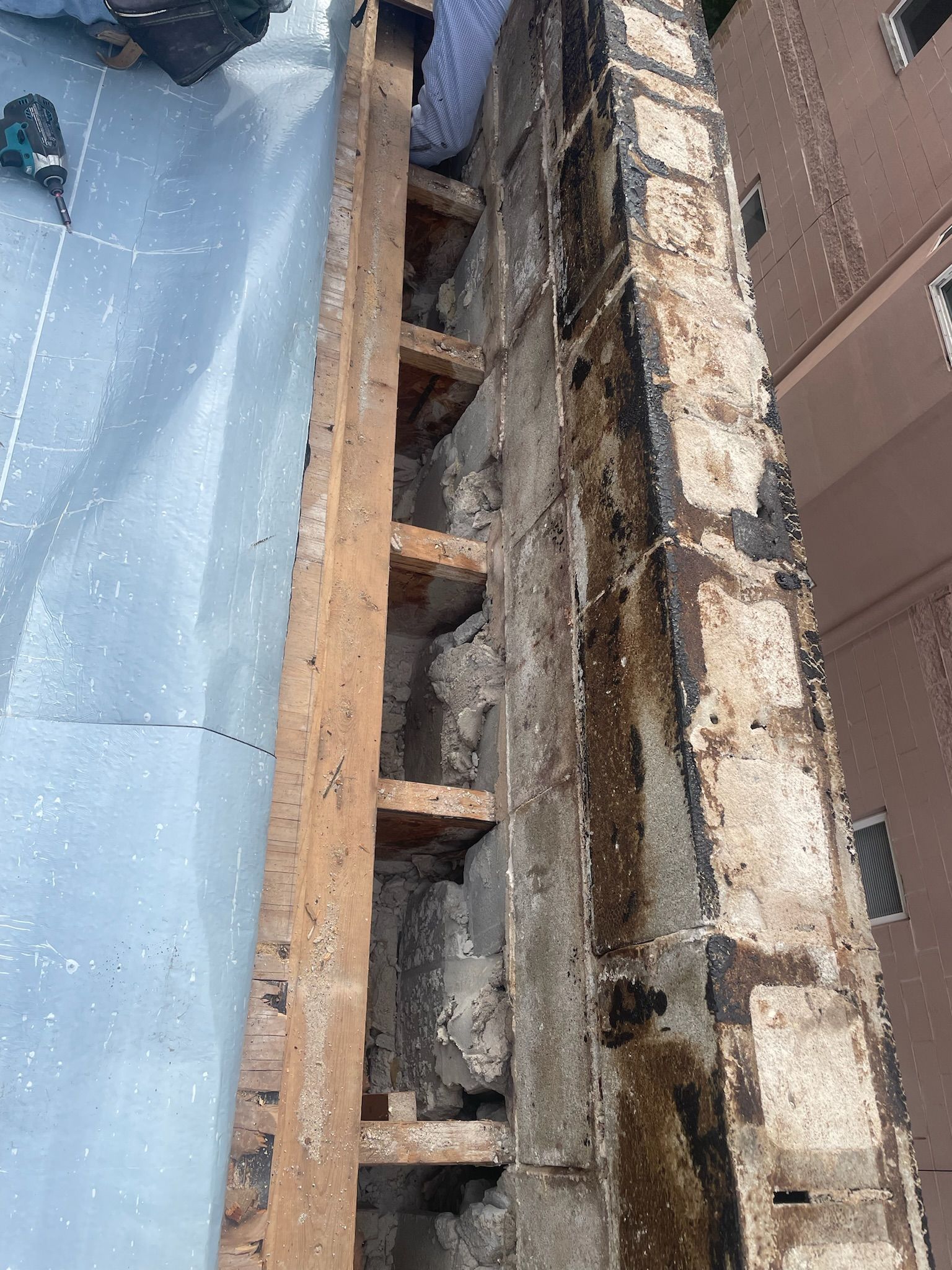 Damaged roof edge with exposed rotting wood
