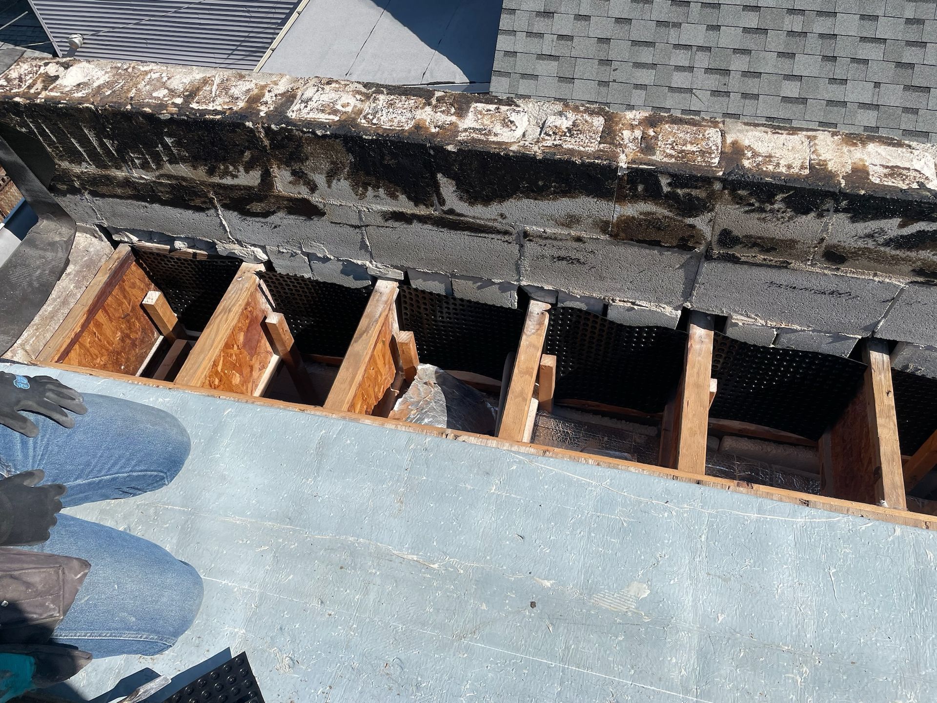Damaged rooftop with exposed wooden trusses