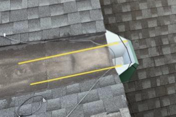 Storm drain on top of shingled rooftop