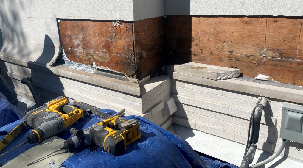 Exposed exterior wall showing rotting wooden wall