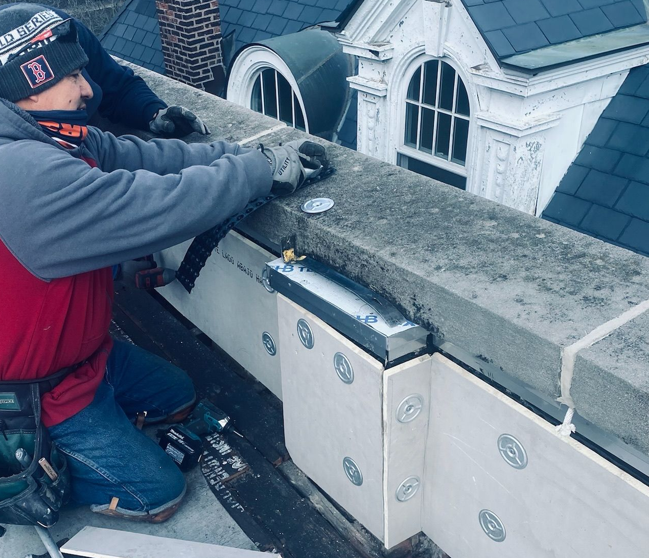 Worker working on a rooftop parapet