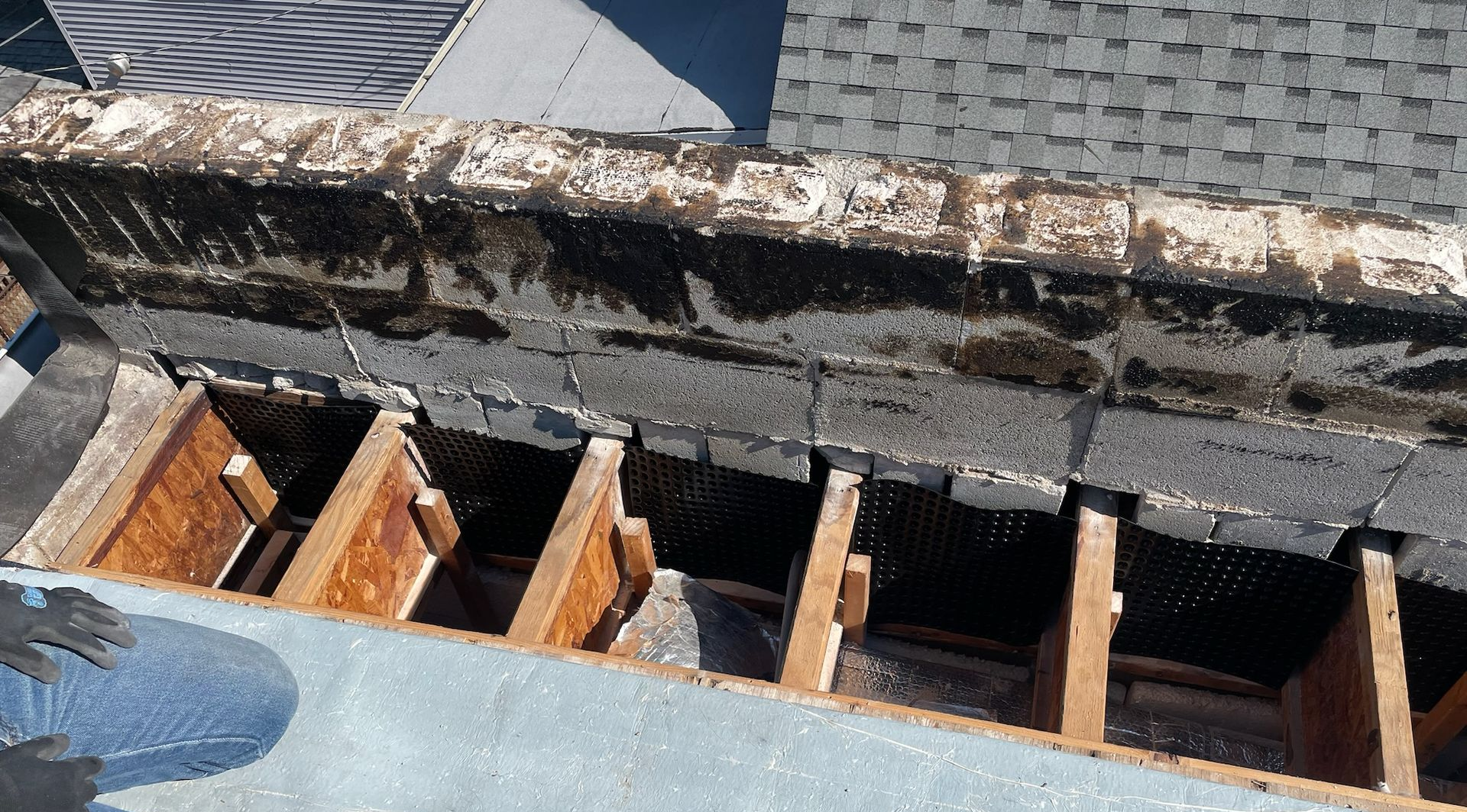 Rotted roof decking with exposed wooden joists