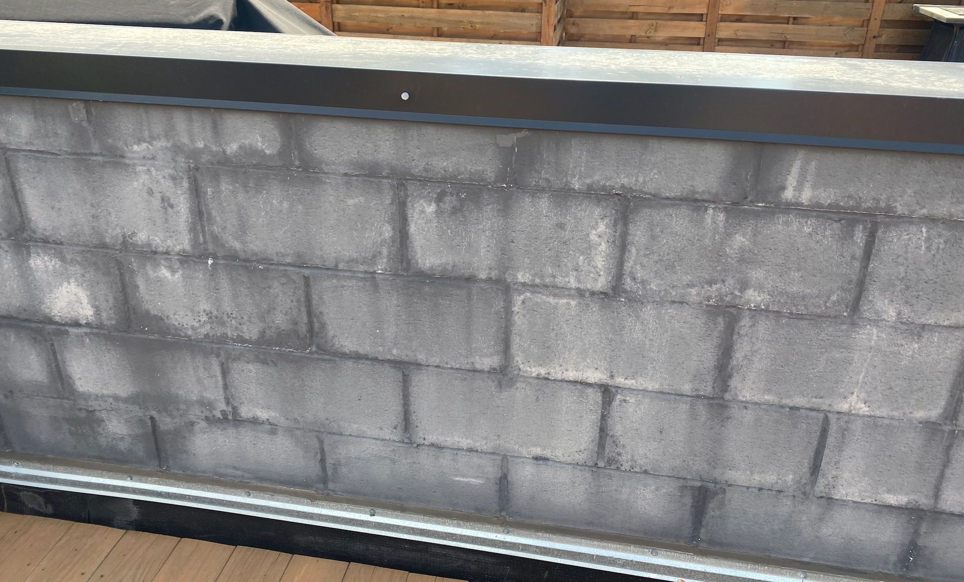 Extremely wet split face block parapet wall with efflorescence