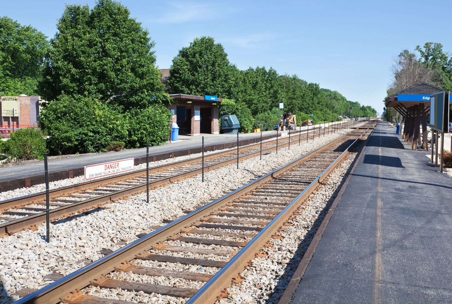 Railroad tracks beside a small station platform