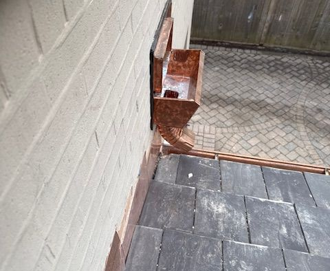 Brick exterior wall with a scupper box